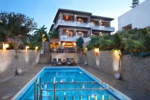 a house with a swimming pool in front of a house at Sun Nicolas in Kato Daratso