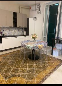 a kitchen with a table with a vase of flowers on it at Dal Console - Piazza Bellini - Napoli in Naples