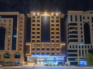 a large building with lights on top of it at Manazel Al Zaireen Hotel in Makkah