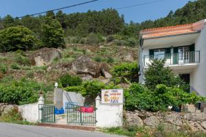 a house with a sign in front of it at A Casa da Rapariga de Cabelo Azul in Manteigas