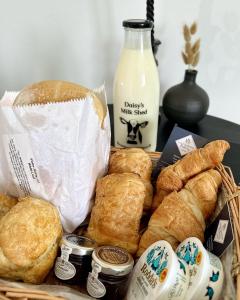 a basket of bread and pastries and a bottle of milk at The Saddle Inn, Snetterton Circuit in Norwich