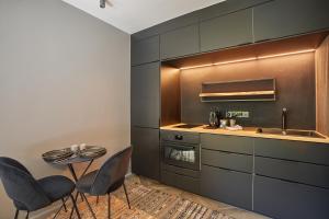 cocina con mesa, sillas y fregadero en Studio in Neuilly Porte Maillot by Studio prestige, en Neuilly-sur-Seine