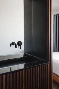 a bedroom with a bed and a black cabinet at Lisbon Five Stars Alcântara Lofts in Lisbon