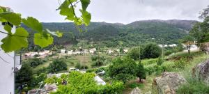 a view of a village in the mountains at A Casa da Rapariga de Cabelo Azul in Manteigas