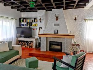 a living room with a fireplace and a tv at O Refúgio in Coimbra