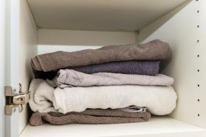 a pile of towels are stacked in a closet at Come Stay in Penthouse With Room For 2-People in Aarhus +24 photos