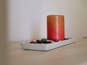 a candle sitting on top of a white plate at Vironas Hotel in Himare