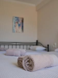 a towel sitting on top of a bed at Vironas Hotel in Himare