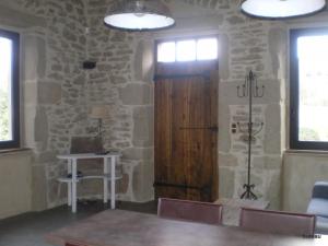 a room with a wooden door in a stone wall at Petit Gite De La Renaissante in Peyrins