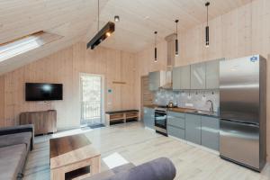 a large kitchen with a stainless steel refrigerator at SPILAS in Pape