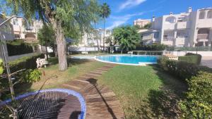 a swimming pool in the yard of a apartment at Bungalow sol y playa in El Campello