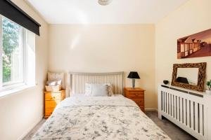 a bedroom with a bed and a mirror at Charming Entire 2-Bedroom House in Milton Keynes in Milton Keynes