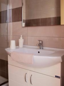 a bathroom with a sink with a towel on it at Vironas Hotel in Himare