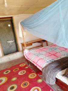 Llit o llits en una habitació de Osikinai mara guest house