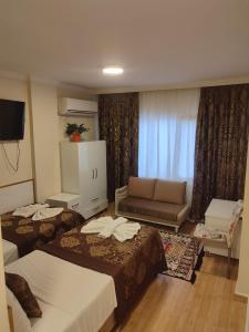 a hotel room with two beds and a couch at Hotel Best Apart in Istanbul