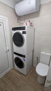 a microwave sitting on top of a toilet in a bathroom at Сарафово Център in Burgas City