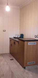 an empty kitchen with a counter in a room at flamingo hotel irbid in Zabdah
