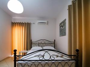 a bedroom with a bed in a room at Vironas Hotel in Himare
