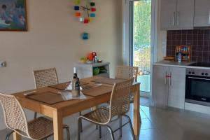 a kitchen with a wooden table and chairs in a room at The Ruby Cottage in Sami +22 photos