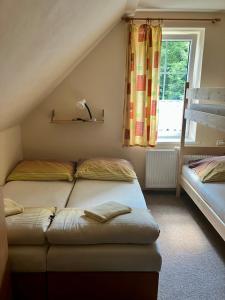 a bedroom with two beds and a window at Chata Tereza in Janov nad Nisou