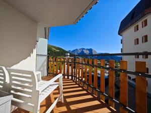 a balcony with chairs and a view of the mountains at Hostdomus - Oak Luxury Suite in Sestriere