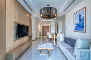 a living room with a couch and a tv at Vinhome Central Park Apartment in Ho Chi Minh City