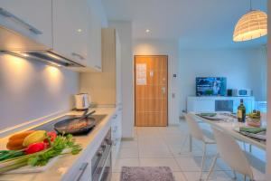 a kitchen with a counter with a bowl of vegetables on it at Prestige du Lac 27 - Happy Rentals in Lugano