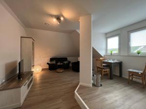 a living room with a tv and a couch at Ferienwohnung Wicki in Kluse