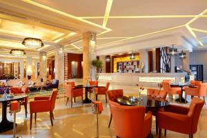 a restaurant with tables and chairs and a bar at Pickalbatros White Beach Resort - Hurghada in Hurghada