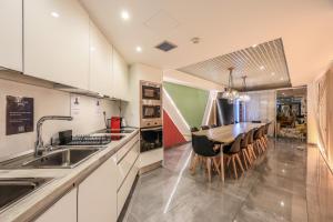 a kitchen with a sink and a table with chairs at AmazINN Places Chamberi in Madrid +217 photos
