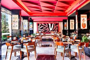 a restaurant with tables and chairs and pink ceilings at Pickalbatros White Beach Resort - Hurghada in Hurghada