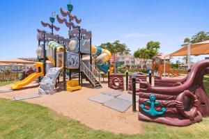 a park with a playground with a slide and slidesktop at Pickalbatros White Beach Resort - Hurghada in Hurghada