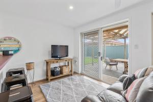 a living room with a couch and a tv at 3 Parrumba Drive Normanville in Normanville