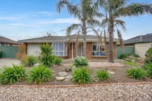 a house with palm trees in front of it at 3 Parrumba Drive Normanville in Normanville