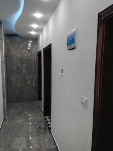 a bathroom with a television on a white wall at شقة فاخرة مع مطل in Amman