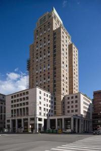 a large tall building on a city street at Appartamento Cristoforo Colombo in Genoa