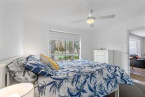 a bedroom with a blue and white bed and a window at 3 Parrumba Drive Normanville in Normanville