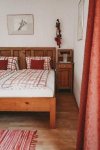 ein Schlafzimmer mit einem Holzbett und einem Nachttisch in der Unterkunft Kultur Weingut Kästenburg in Ratsch an der Weinstraße