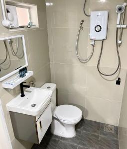 a bathroom with a toilet and a sink and a shower at Blue Cabins By Pfordten Cottage in Cameron Highlands