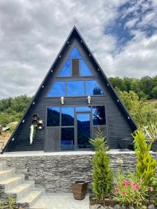 a house with a gambrel roof with a large window at A Frame Lerik in Lerik