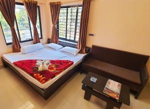 a small bedroom with a bed and a couch at Baranti Eco Tourism Resort, Muradi 