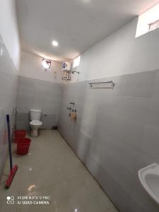 a bathroom with a toilet and a sink at Baranti Eco Tourism Resort, Muradi 