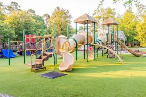 a playground with a slide in a park at Calypso Cottage in Bluffton