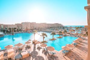 an overhead view of a large swimming pool with umbrellas at Pickalbatros White Beach Resort - Hurghada in Hurghada