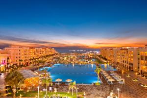 a view of a harbor in a city at night at Pickalbatros White Beach Resort - Hurghada in Hurghada