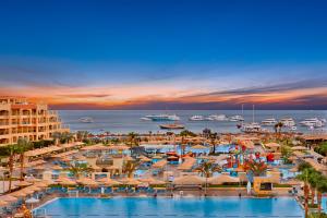 a resort with a large swimming pool and a beach at Pickalbatros White Beach Resort - Hurghada in Hurghada
