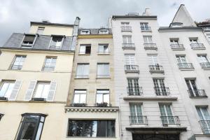 an apartment building in paris with windows at Apartment Saint Germain des Prés by Studio prestige in Paris