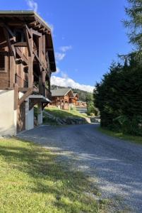 an empty road next to a wooden building at Chalet Pierre, Les Gets in Les Gets