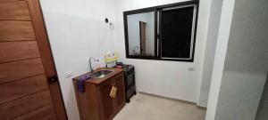 a small bathroom with a sink and a mirror at Apartamento Avenida in Sal Rei