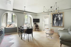 a kitchen and living room with a table and chairs at Apartment Saint Germain des Prés by Studio prestige in Paris